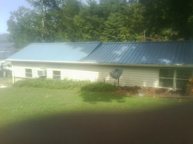 Blue metal roof running the length of a single story home in Pittsfield