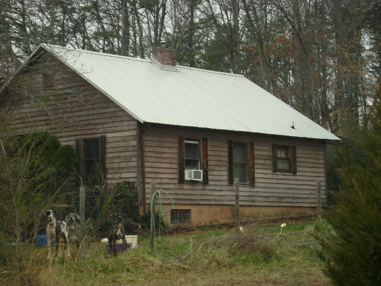 White metal roof on an old wood sided farmhouse, from a Metal Roof Installation job in Pittsfield